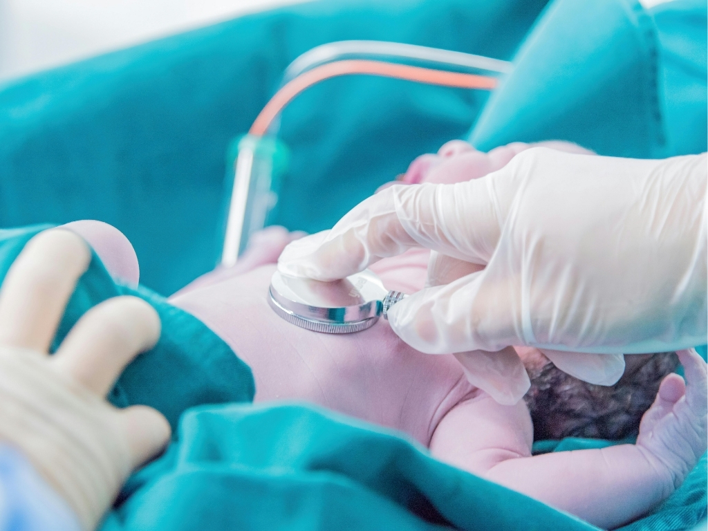 Stethoscope scanning a baby